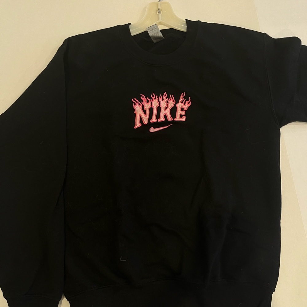 Black embroidered sweatshirt with pink flaming Nike Logo. Small